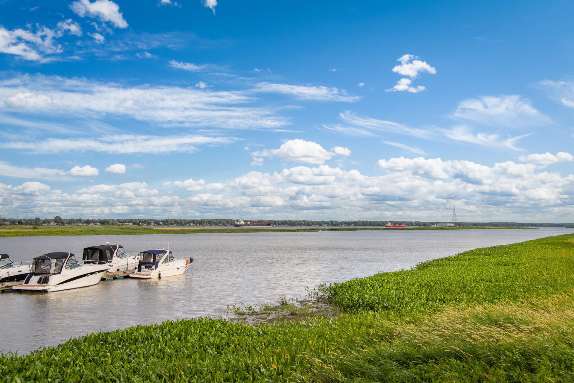 Boats moored along the shore of the St. Lawrence River in Quebec, Canada