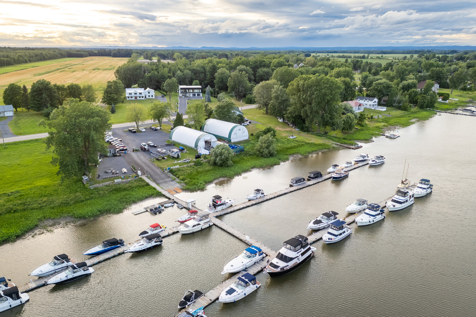 Aerial view of a marina with yachts on the St. Lawrence River, across from Villa Océane