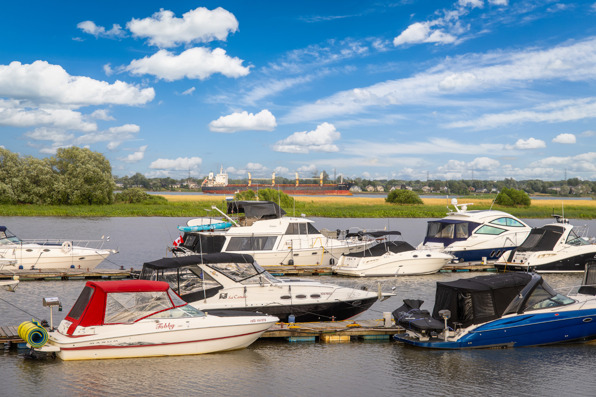 Marina and boats on the St. Lawrence River near a luxury home for sale